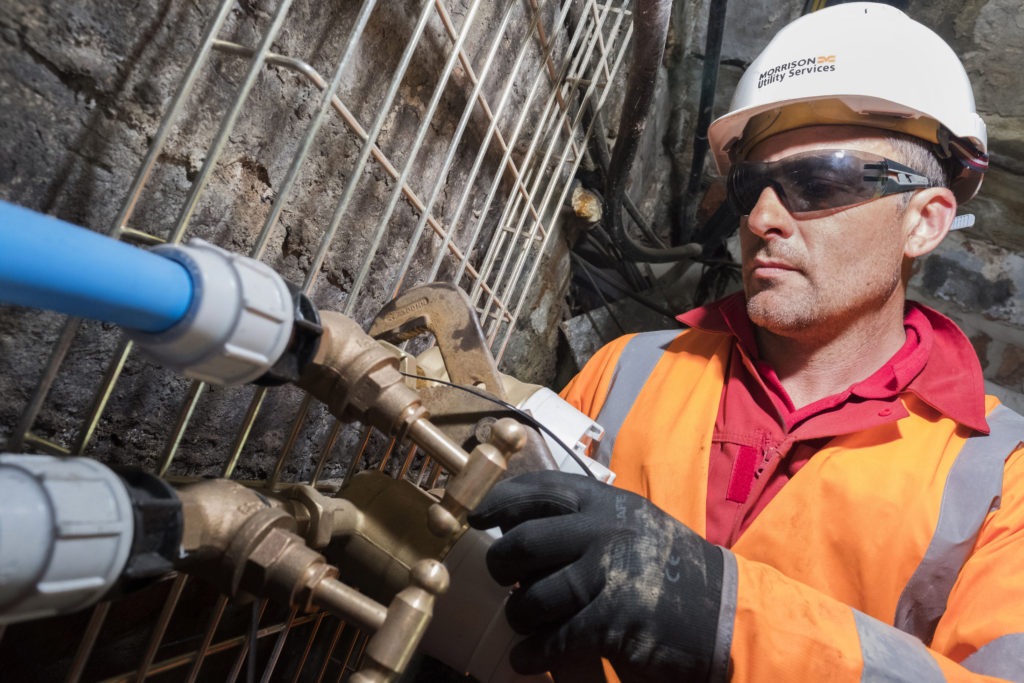 A Morrison Utility Services technican repairing a water pipe